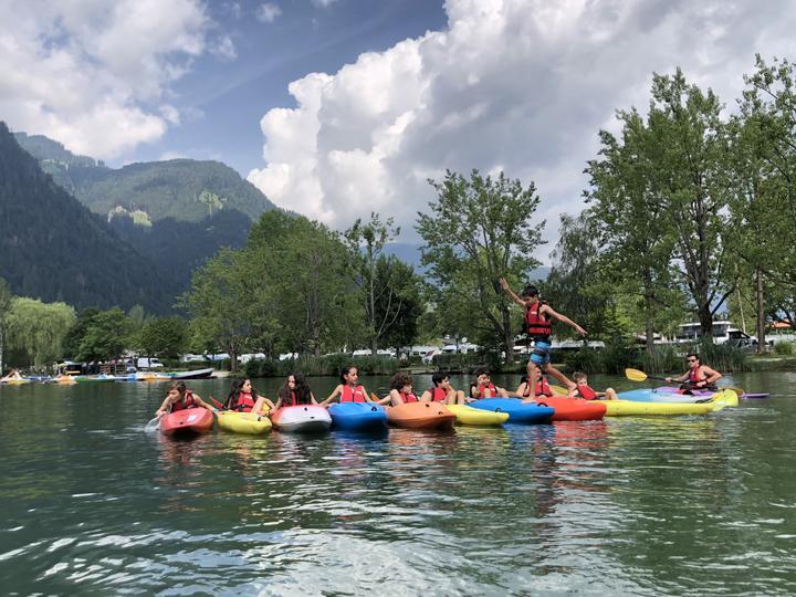 Campers floating on inflatables on the lake