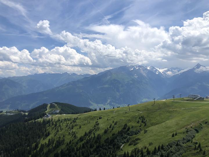 View over green Alpine meadows to the mountains around Zell am See