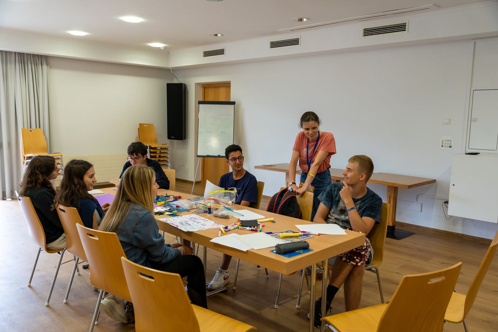 Small language class working around a table with their teacher