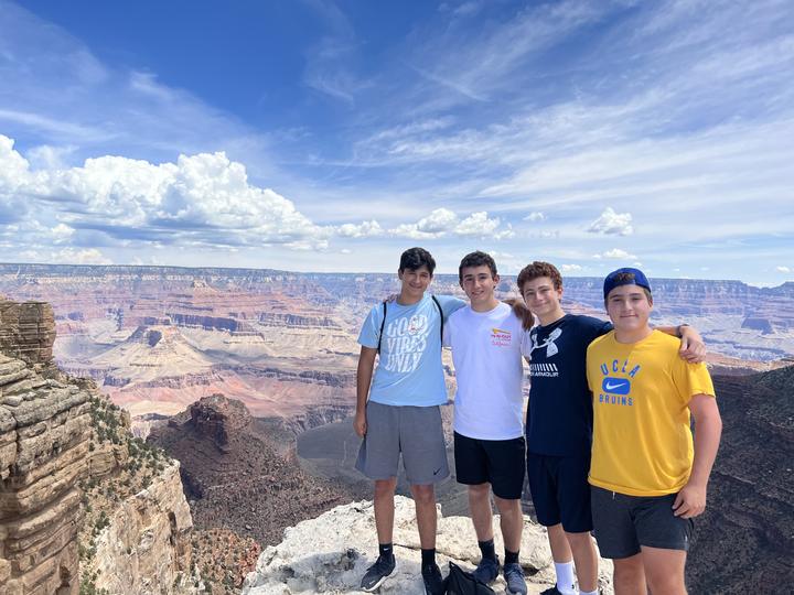 Four boys at the edge of the Grand Canyon