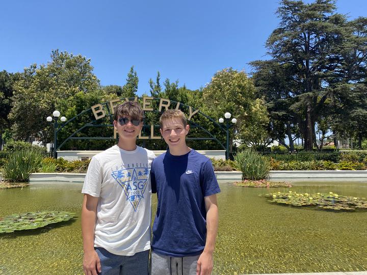 Two boys at the Beverly Hills sign