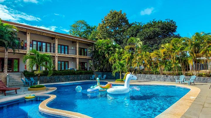 Hotel pool surrounded by palm trees in Costa Rica