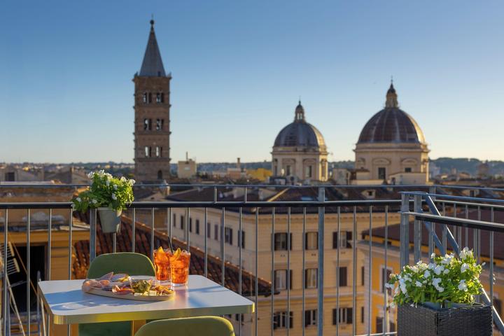 Hotel rooftop terrace in Rome with church domes behind