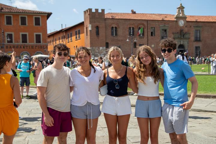 Five teens in a historic Italian piazza