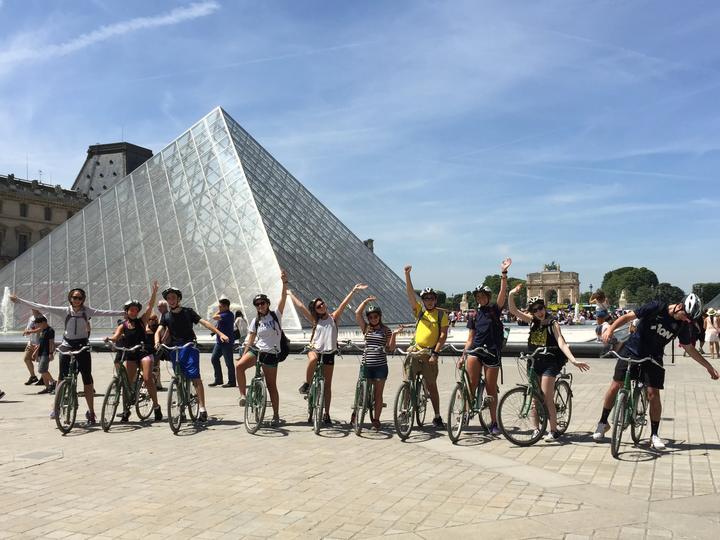 The group on bikes by the glass pyramid at the Louvre