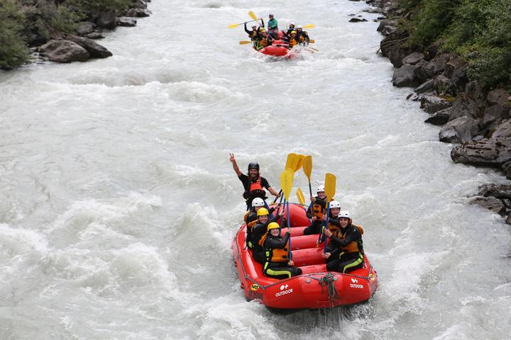 Rafts of teens in whitewater near Interlaken