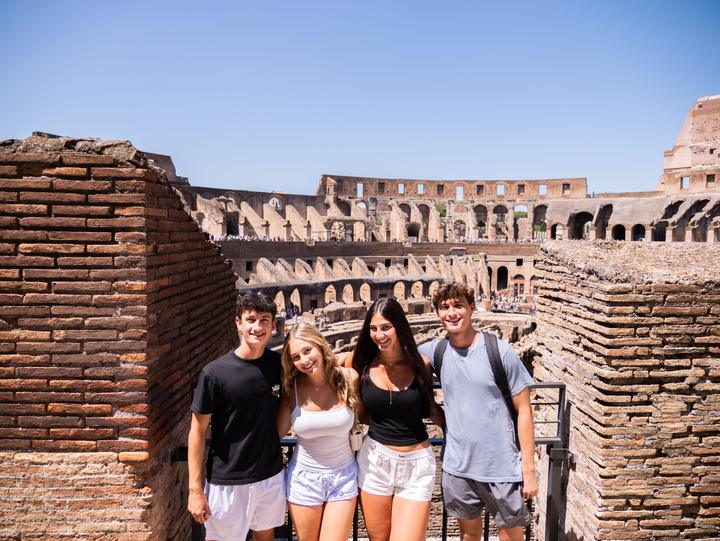 Four teens inside the Colosseum in Rome