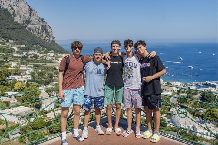 Five teens at a viewpoint high above the sea on Capri
