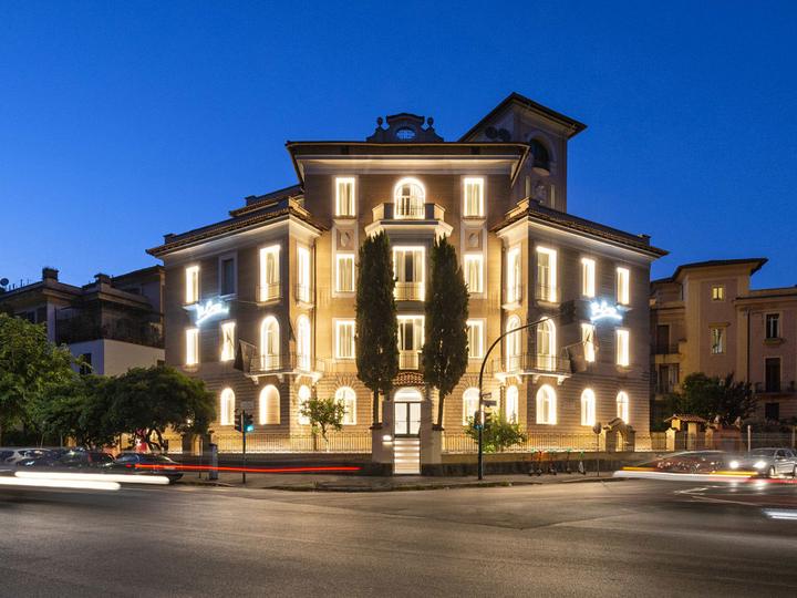 One of the group's hotels in Italy, lit up at dusk
