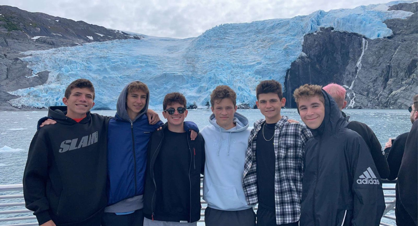 Six boys in front of a glacier in Alaska