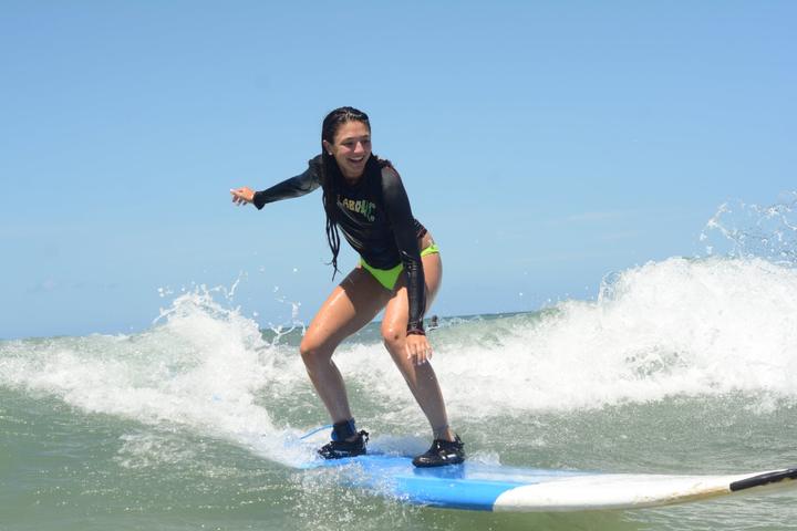 A girl surfing a breaking wave