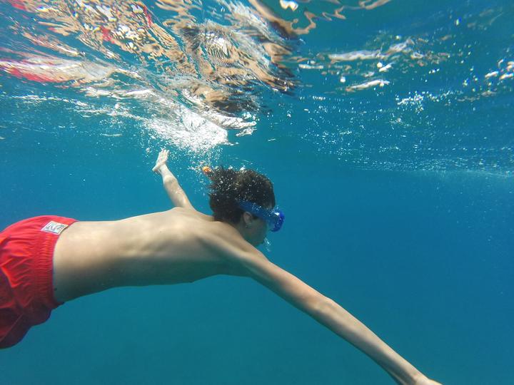 A boy snorkelling underwater