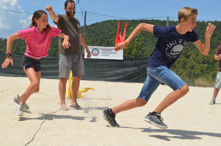 Teens racing in a team game on the sports court