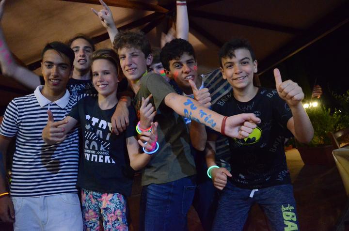 Teens cheering and posing at the camp disco