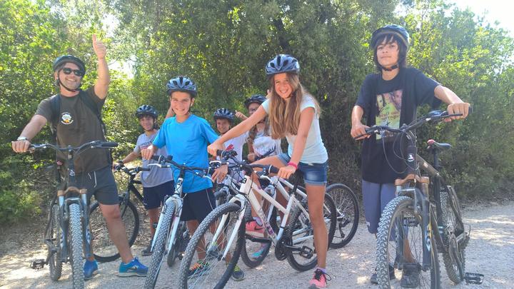 Teens in bike helmets with their mountain bikes, ready to ride