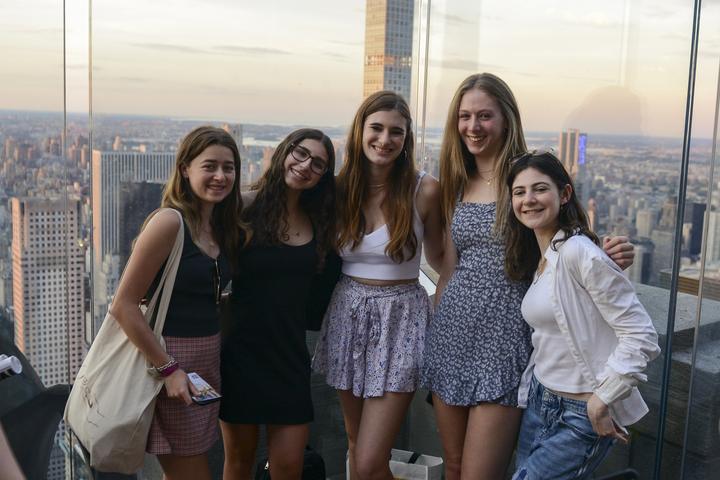 Girls at a skyscraper observation deck high above New York