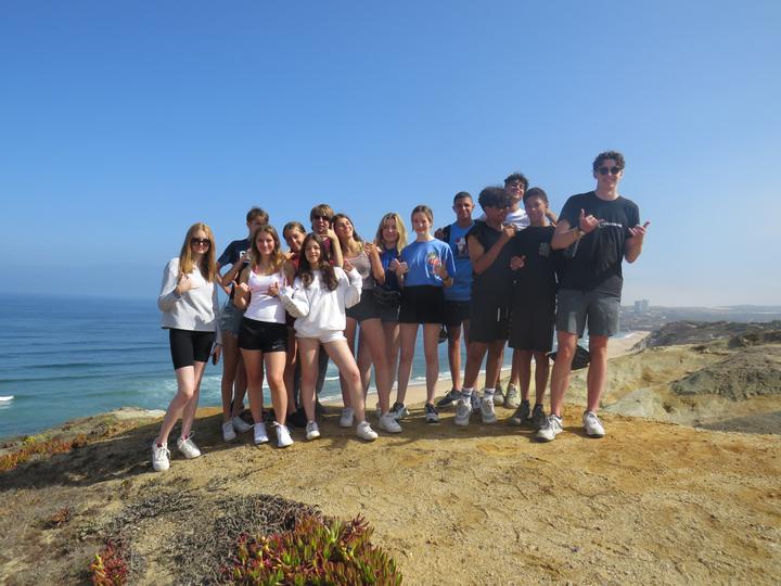 Group of campers posing on the cliffs above the Atlantic