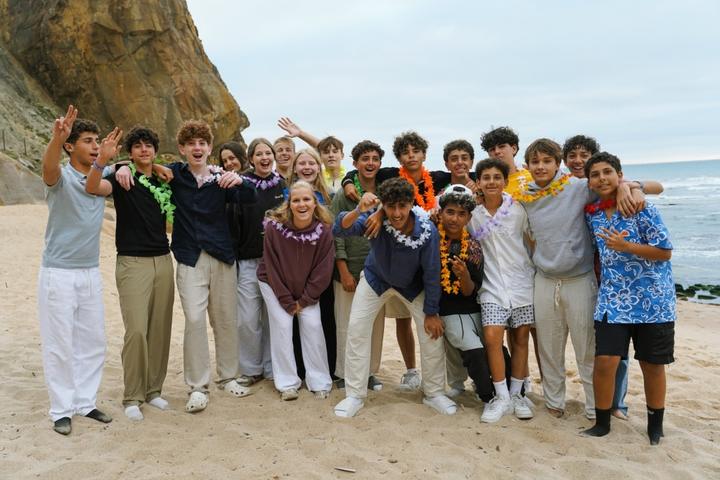Large group of international campers together on the beach