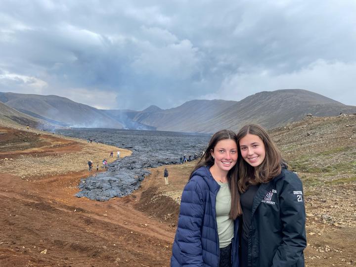 Two girls in front of a steaming lava field in Iceland