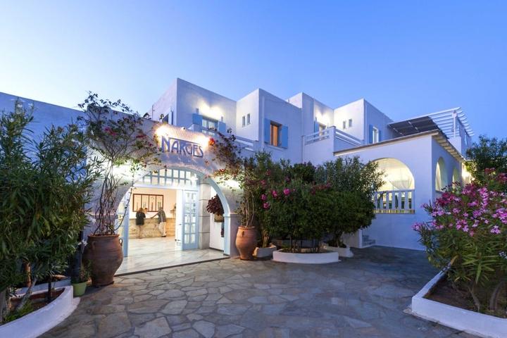 Whitewashed hotel entrance with flowers on Paros