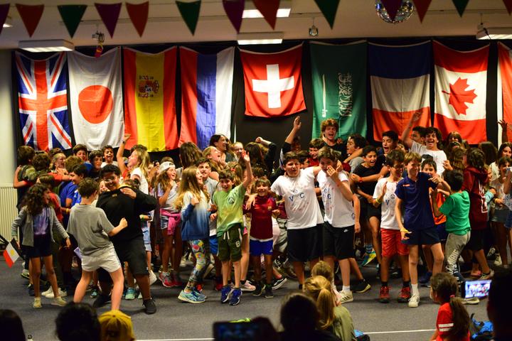 Camp disco in the hall decorated with flags from around the world