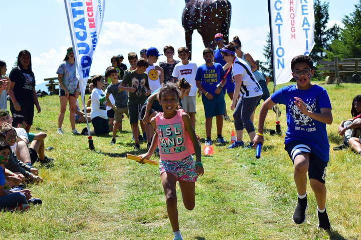 Campers racing across the field on an all-camp games day