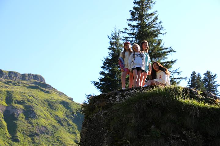 Campers on a rocky outcrop on a mountain hike