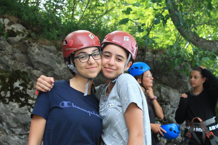 Two campers in climbing helmets