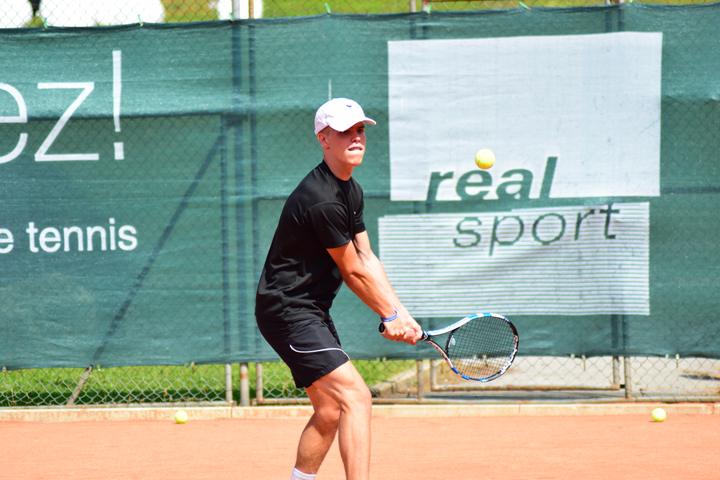 Teen player hitting a two-handed backhand