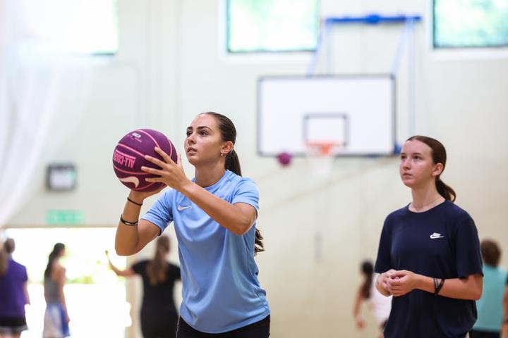 Two girls working on their shooting form
