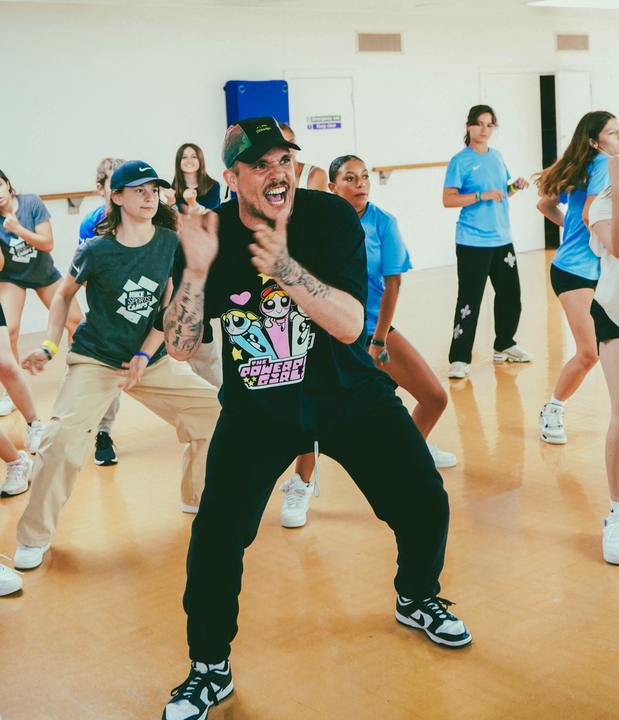A teacher demonstrating a freestyle move to the group