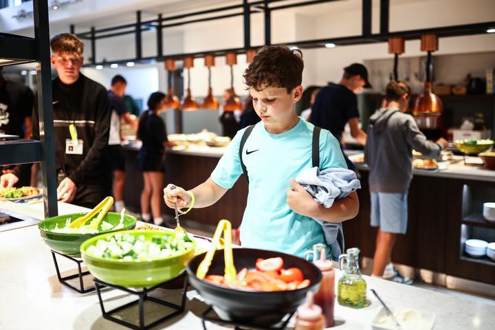 A camper helping himself at the salad bar