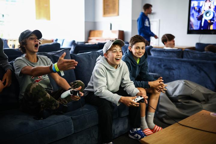 Campers laughing on the sofas in the players' lounge