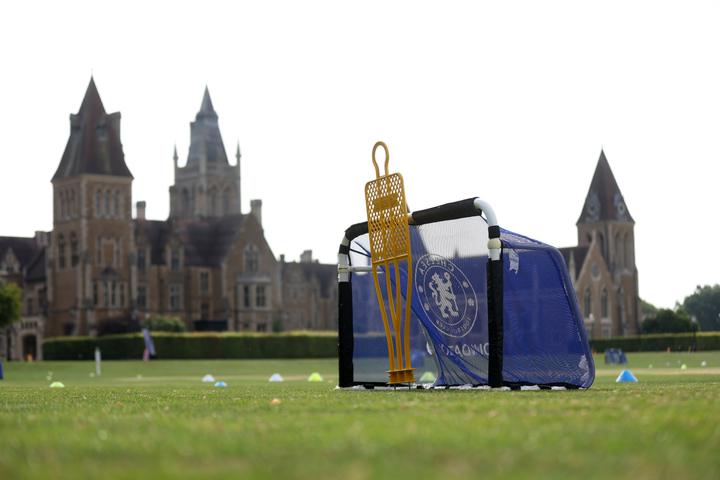 Chelsea FC training equipment on the pitch in front of Charterhouse's Gothic buildings