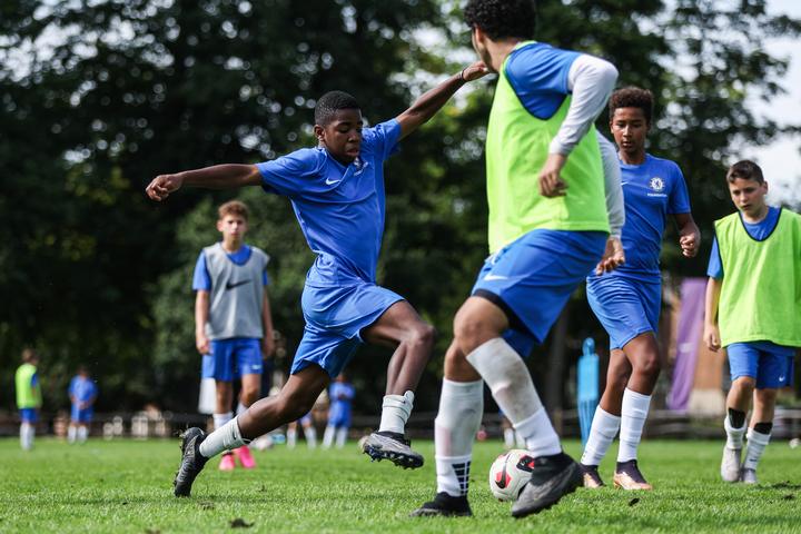 A player stretching into a tackle during match play
