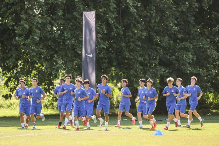 A group of players jogging through a warm-up