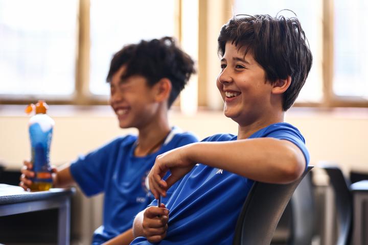 Two young campers laughing during a break