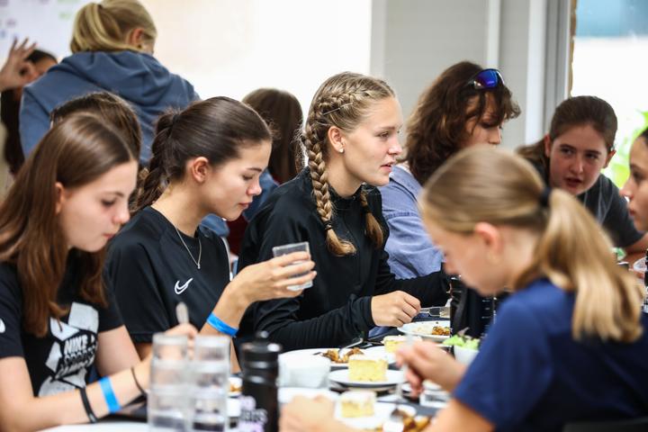 Volleyball campers chatting over dinner