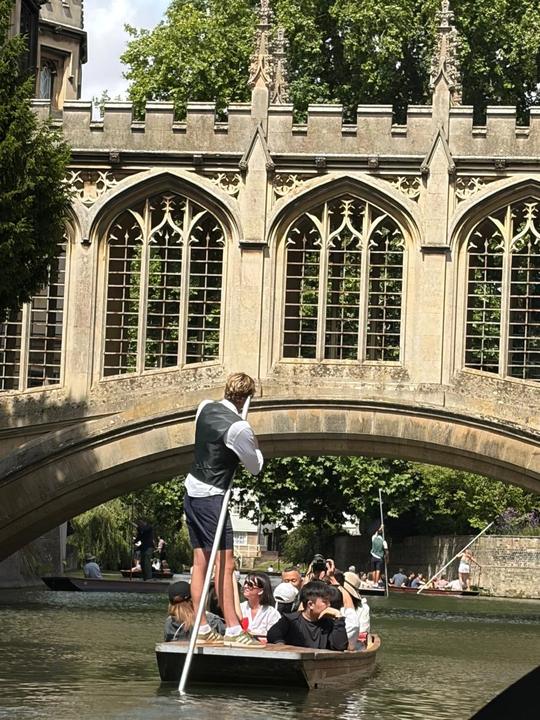 Punting under a college bridge in Cambridge
