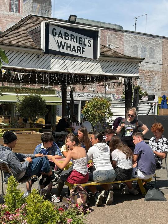 Class at outdoor tables at Gabriel's Wharf on the South Bank