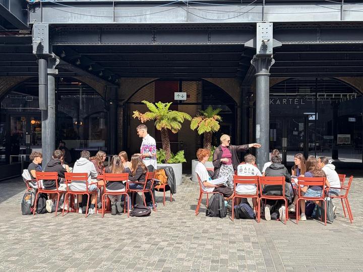 Classes at outdoor tables in a London courtyard
