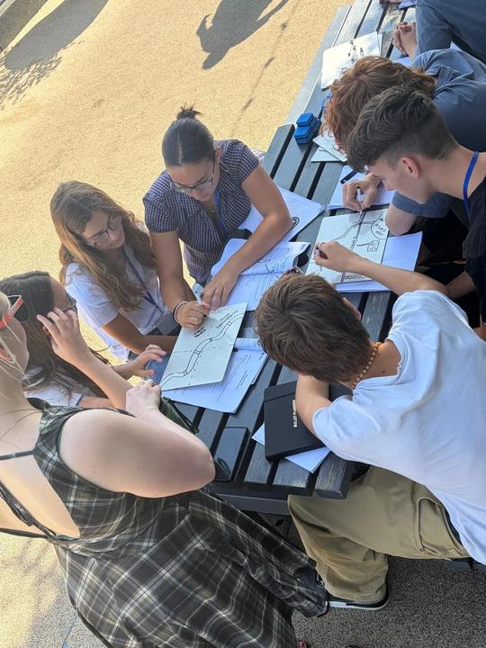 Teens working on a lesson at an outdoor table