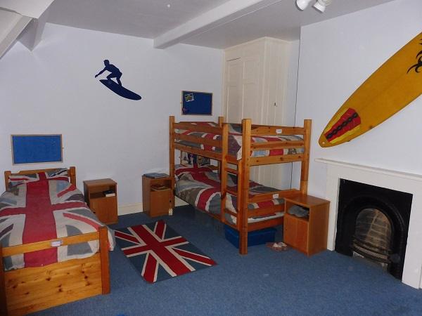 A boys' room with bunk beds and a surf theme