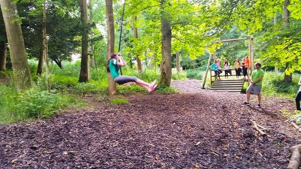 A rope swing on a woodland obstacle course