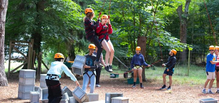 Campers taking on the crate-stack challenge