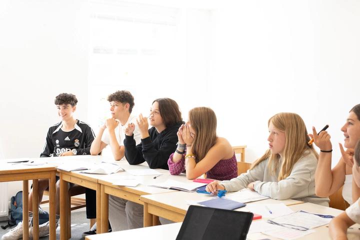 English lesson with teenagers around a classroom table