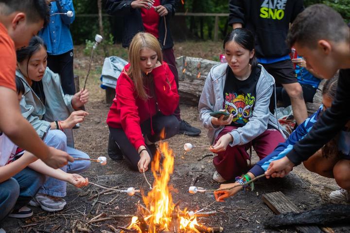 Students cooking over a campfire