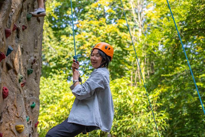 Smiling student on the climbing wall