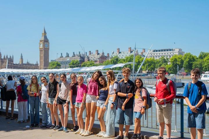 Group of campers by the Thames with Big Ben behind them