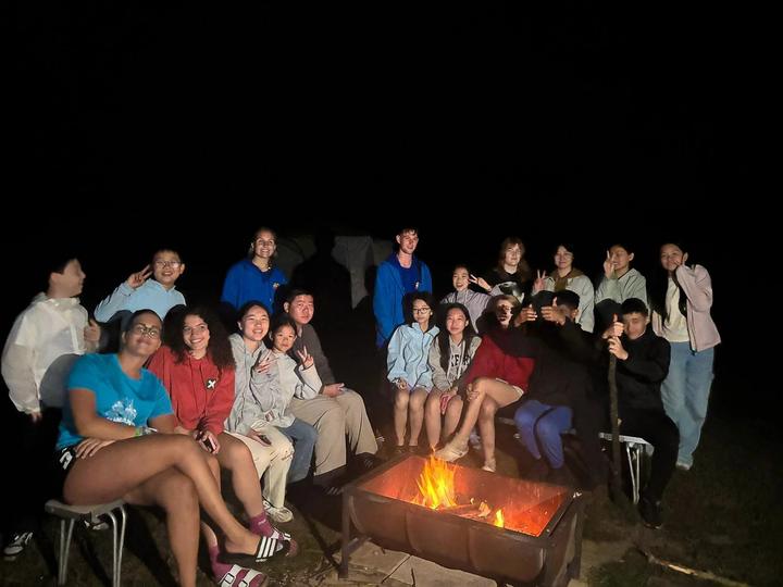 Campers gathered around the evening campfire